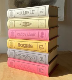 a stack of books sitting on top of a wooden table