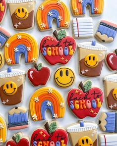 decorated cookies are arranged in the shape of rainbows, apples, and other things