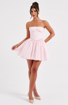 This mini is having a moment! Made in a premium cotton blend fabric, this strapless design features a boned corset to snatch the waist and a super full skirt. The look is complete with delicate lace trims and shirring to the back. 



Colour: Blush.

Premium non-stretch cotton blend fabric.

Fully lined.

Strapless with lace trim.

Gathered, underwired cups.

Boning in corset.

Lace trim detail.

Super full skirt.

Shirred back detail.

Mini length.

Model is an XS and is wearing an XS.

 Size: Short Corset Dress, Homecoming Dresses Corset, 23 Birthday, Corset Dresses, Long Sleeve Homecoming Dresses, Prom Inspo, Hoco Dress, Maxi Dress Sale, Corset Mini Dress