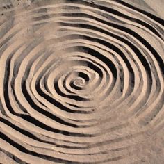 a circular design made out of sand on the beach