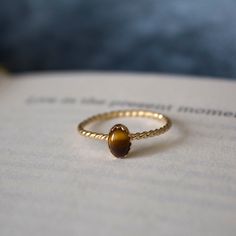 STUNNING 14k gold filled handmade tigers eye ring ✨ * Listing covers just the single tigers eye ring, other rings are sold separately. Beautiful 6x4mm tiger eye gemstone Tigers Eye is a member of the Chalcedony mineral class family. It has a silky luster and an opaque transparency. Tiger's Eye is commonly a metamorphic rock that comes in shades of reddish brown with iron stripes. The meaning of Tigers Eye is self-confidence and inner strength. Traditionally tigers eye was used to ward off curses Tiger Eye Engagement Ring, Tigers Eye Engagement Ring, Tiger Eye Ring For Women, Layered Rings Gold, 22k Gold Rings, Tigers Eye Jewelry, Tigers Eye Ring, Brown Ring, Class Family