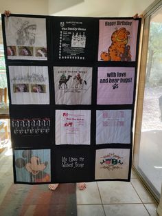 a quilt made to look like winnie the pooh is hanging in front of a window