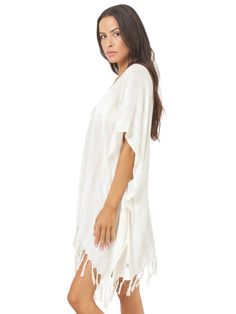 Effortlessly chic, L Space V-neck poncho offers a blend of style and comfort. With its waist tie and back-of-neck fastening, it ensures a secure fit while exuding bohemian charm with its playful tassel hem. Perfect for layering over your favorite swimsuit or pairing with denim for a laid-back beachside look.
 Size: XS/S, M/L Casual V-neck Cover-up With Tassels, Chic Beige V-neck Cover-up, Vacation V-neck Kaftan With Tassel Ties, Casual V-neck Beach Poncho, Chic V-neck Festival Cover-up, Casual V-neck Festival Cover-up, Spring Vacation V-neck Poncho, Casual V-neck Tassel Cover-up, Chic Tunic Cover-up For Festival