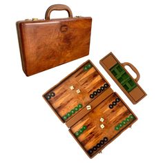 an old wooden board game set with pieces in the middle and two cases on top