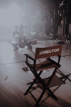 a director's chair sits in the middle of a stage with lights behind it