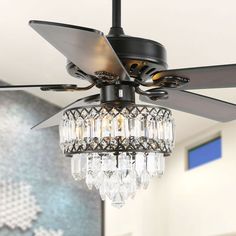 a black ceiling fan with crystal chandelier hanging from it's center blade