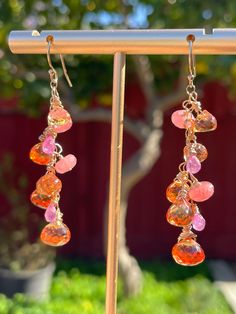 "These are a companion piece to the sold-out Pink and Tangerine Sapphire necklace; they're made with the same orange Padparadscha sapphires, but focusing on the orange/yellow/coral hues. They're still garnished with faceted AAA+ quality rhodochrosite rondelles, tiny mandarin garnets, and pink sapphire teardrops. Available in 14K yellow gold-filled, rose gold-filled, or sterling silver. *And now available in solid 14K yellow gold! (please allow 1-2 weeks for customization.)* They measure 2\", and Orange Gemstone Dangle Jewelry, Fusion Multi-stone Pink Jewelry, Orange Briolette Jewelry For Gift, Orange Gemstone Drop Jewelry, Orange Drop Gemstone Jewelry, Fusion Style Pink Jewelry With Gemstone Accents, Fusion Style Pink Dangle Jewelry, Pink Fusion Dangle Jewelry, Pink Fusion Style Dangle Jewelry