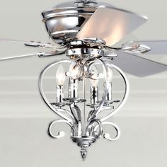 a ceiling fan with three lights and a light fixture in the middle of it's blades