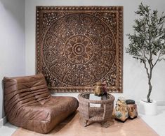 a living room with leather furniture and a large tapestry on the wall