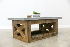 a table made out of wood with a potted plant on top