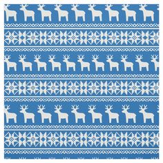 a blue and white knitted pattern with reindeers on the front, in snowflakes