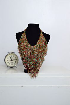 Unique African Maasai Handcrafted Beaded Necklace with an Elegant Look and Brilliant Finish. Circumference = 16 Inches/ 41 Centimeters. Color =Multi-Color Maasai Beads. Fringe = 10 Inches / 26 Centimeters. **GET FREE SHIPPING FOR ADDITIONAL ITEMS PURCHASED. Yes, Buy Multiple Items and pay shipping for 1 item only- The rest ships Free. (No Limits on the number of Multiple items). With a faster delivery time of 3 days via DHLExpress, Worldwide. Ordinary/Standard Shipping also available upon reques Traditional Multicolor Jewelry With Beaded Fringe, Bohemian Bib Necklace With Round Beaded Chain, Bohemian Bib Necklace With Beaded Chain, Bohemian Bib Necklace With Round Beads, Traditional Multicolor Beaded Fringe Necklaces, Traditional Multicolor Beaded Necklaces With Fringe, Traditional Multicolor Beaded Necklace With Fringe, Bohemian Multi-strand Beaded Bib Necklaces, Bohemian Beaded Multi-strand Bib Necklaces