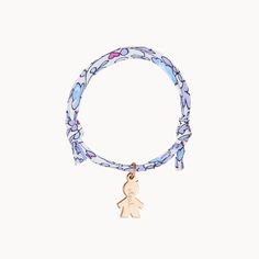 For a little one who loves to match with mommy, our Children’s Personalized Boy Liberty Bracelet is the perfect gift for a birthday, christening or milestone moment. Each bracelet can be personalized to capture their unique personality, with a choice of five colourful Liberty braid prints and their name hand-engraved onto the mini boy charm.18K Champagne Gold Plated, 925 Sterling Silver or 18K Rose Gold PlatedMini Boy: &nbsp;0.47 x 0.31Liberty braid with fully adjustable sliding knot fasteningHand-engraved in our Paris workshopSent with love in a complimentary gift boxAny slight variations in lettering depth, spacing and alignment from the examples shown are part of the aesthetic and originality of the pieceChildren’s Warning: please note, this piece of jewelry is not a toy. We advise Personalized Silver Playful Charm Bracelet, Mother's Day Personalized Pink Charm Bracelet, Liberty Bracelet, Mother's Day Gold-toned Charm Bracelet, Personalized Name Charm Bracelet, Adjustable, Personalised Baby Bracelet, Sliding Knot, Champagne Gold, Personalised Kids