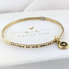 "Forever in my Heart Bracelet, Memorial Bracelet, In Memory Of, Personalized Bracelet, Sympathy Gift Mother, Sympathy Bracelet, Mom Dad Customize our NEW riveted bangle bracelets with your favorite word/s, meaningful phrase, special saying, names of loved ones, grandchildren, dates and even coordinates for the place you met your partner or shared a special moment with someone. This beautiful bracelet has a dangling heart charm We customize each bangle with your favorite quote, phrase or children Adjustable Heart Charm Jewelry Keepsake, Inspirational Heart-shaped Adjustable Bracelets, Personalized Round Bracelets For Keepsake, Hand Stamped Meaningful Bracelet For Anniversary, Engraved Heart Bracelets For Friendship, Heart Shaped Engraved Bracelets For Friendship, Heart-shaped Engraved Friendship Bracelet, Engraved Adjustable Heart Bracelet For Anniversary, Adjustable Bracelet For Mother's Day Keepsake