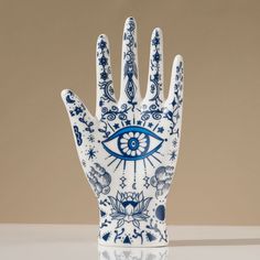 a ceramic hand with an eye painted on it