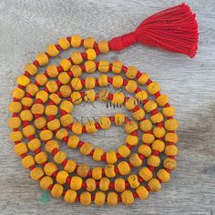 📿This Mala is handcrafted with Turmeric Beads. Turmeric is much revered by Hindus and is considered one of the most purifying herbs in Ayurveda. Each Bead is mindfully knotted with love, one at a time on a durable nylon silk chord for extra strength, to extend their lives & is finished with a Silk Tassel adorned with silver Zari. Historically, the tassel has worked as a talisman and is used as a sign of power, prestige, protection, and spiritual significance . One who wears / keeps Turmeric mala also acquires a good amount of spiritual powers.📿 📕 MATERIALS 📕 🦉Turmeric Beads 🦉Nylon Silk Cord 🦉Silk Tassels 🦉Silver Zari 📕 PRODUCT DIMENSIONS 📕 📏Mala Necklace Length: 41-43 inches approx 📏Tassel Length: 3.5 - 4.0 inches approx 📏Shape : Round 📏Size : 8 MM 📏Number Of Beads: 108 Mala Traditional Beads For Beach Festivals, Handmade Beaded Necklaces For Puja Festivals, Artisan Beads For Rituals And Festivals, Traditional Hand-strung Beads For Beach, Handmade Orange Jewelry For Puja, Traditional Orange Beads For Gifts, Yellow Hand-strung Jewelry For Meditation, Orange Beaded Necklaces With Wooden Beads As Gift, Orange Beaded Necklaces With Wooden Beads For Gifts