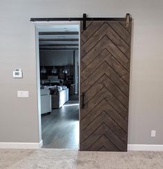 an open sliding door in a living room with grey walls and white carpeted flooring