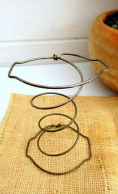 a wire sculpture sitting on top of a table next to a potted plant