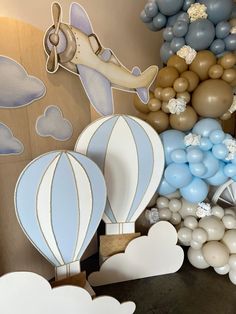 balloon decorations and balloons in the shape of animals, planes, and clouds are on display