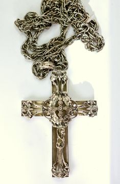 Vintage Metal Cross Necklace, Vintage Cross Chain Jewelry, Vintage Antique Silver Cross Necklace, Vintage Silver Engraved Cross Necklace, Vintage Cross Necklace In Metal, Vintage Engraved Silver Cross Necklace, Vintage Metal Crucifix Cross Necklace, Vintage Metal Cross Pendant Necklace, Ornate Silver Cross Necklace