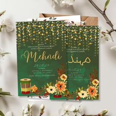 two green and yellow wedding cards with flowers on the front, one is for mehndi up