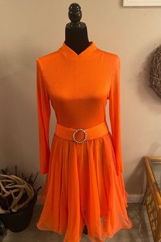 Vintage orange chiffon dress by Miss Elliette California with detachable rhinestone snap belt. Dress is long sleeved and hits below the knee. Dress has a back zipper and hook and eye closure.  Skirt is fully lined with a sheer chiffon overlay. Labeled as a size 14. Orange Stretch Evening Dress, Elegant Stretch Orange Dress, Elegant Orange Stretch Dress, Formal Orange Knee-length Mini Dress, Elegant Orange Mini Dress For Evening, Orange Knee-length Mini Dress For Evening, Orange Mini Dress For Evening, Elegant Orange Mini Dress For Formal Occasions, Orange Long Sleeve Formal Dress