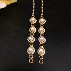 Kundan Earring Support Chain/ Golden Ear Chain/ Kundan Earrings Support Chain/ Kaan Chains/ Earrings Sahara / Jewelry Accessories/ Maatal Features: Made in Brass with 22 Karat Gold plating with Kundan Stones Pair of Two Earrings Support Chains - One for each Ear Used for Earrings Support  Approx. 5 to 5.5 Inches in Length Best support chain for earrings, Studs, Chandbali, and Jhumkas Easy to attach to earrings Maatal Earrings Gold, Gold Dangle Earrings With Beaded Chain, Adjustable Gold Earrings With Beaded Chain, Gold Beaded Chain Earrings For Wedding, Metal Chain Drop Earrings, Metal Pearl Chain Earrings As Gift, Metal Earrings With Pearl Chain As Gift, Metal Earrings With Pearl Chain For Gift, Pearl Chain Metal Earrings For Weddings