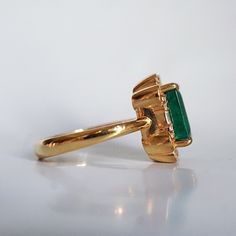 Read about our payment plans before proceeding.The Isis Emerald Scroll Diamond ring is an exquisite piece. Inspired by the details on architectural buildings in NYC, this ring features a stunning natural emerald framed by two baguette diamonds and round diamonds. Made for a true goddess with a touch of vintage vibe. Available in 14K solid yellow gold, white gold, and rose gold. 14K solid gold Natural 9*7mm emerald. Approx. 2.6ct. Comes with a certificate Natural baguette diamonds. Approx. 0.04ct Luxury Gia Certified Cluster Ring In Yellow Gold, Luxury Gia Certified Yellow Gold Cluster Ring, Luxury Emerald Ring With Halo, Gold Emerald-cut Cluster Ring With Halo Design, Gold Emerald-cut Halo Cluster Ring, Gold Emerald Cut Cluster Ring With Halo Design, Classic Yellow Gold Emerald Ring With Halo, Heirloom Gold Emerald Ring With Halo Detail, Heirloom Gold Emerald Ring With Halo