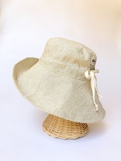 "A sun hat for beach days and summer fun. This sun hat for women has a nice wide brim to protect your whole face and even your neck and chest. A drawstring around the head keeps the hat fitting snug. Easy to bring along in your bag, folds up easy. This hat is made from a medium weight homespun linen and cotton blend fabric in a neutral beige color. Inside liner is white cotton. I used a stiff interfacing for brim to keep it's shape. Brim measures 4.5\" Crown depth is 3.5\". Contact me for custom Hat For Beach, Toddler Tops, Sun Hats For Women, Hat For Women, Neutral Beige, Baby & Toddler Clothing, Beach Days, Sun Hat, Wide Brimmed