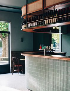 an empty bar with bottles on the shelves