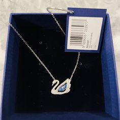 Crystals, Rhodium-Plated And Zirconias With A Blue Stone Set In The Swan’s Center. Minimum 14 7/8 Inches In Length, Max 16 And 7/8. Lobster Clasp. Perfect Condition, Unwornstill Has Tag And Packaging. Swan Necklace Swarovski, Swavorski Necklace, Swan Necklace, Italian Life, Jewelry Swarovski, Halo Necklace, Crystal Jewelry Sets, Swarovski Bracelet, Triangle Studs