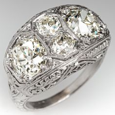 This magnificent antique "Toi Et Moi" ring features a pierced design with engraved details and bordered with milgrain edging. The ring is accented with two (2), prong set, old mine cut diamonds and two (2), prong set, old European cut diamonds. The ring measures 12.6mm at the top, rises 5.4mm above the finger, tapering to 1.9mm wide and 1.1mm thick at the base of the shank. The ring is currently size 5.25. Classic Oval Engraved Ring With Filigree, Antique Filigree Ring With Diamond Accents, Classic Engraved Ring With Intricate Design For Collectors, Ornate Oval Filigree Ring With Rose Cut Diamonds, Collectible Oval Diamond Ring With Intricate Design, Diamond Ring Platinum, Simple Rings, Wedding Simple, Old Mine Cut Diamond