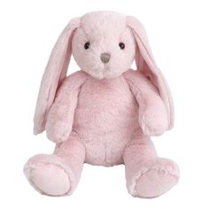 a pink stuffed rabbit sitting up against a white background