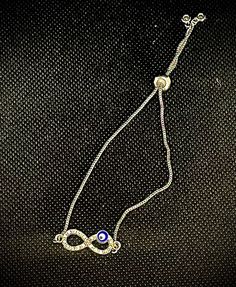 Silver plated chain with evil eye infinity, charm bracelet. Silver Infinity Bracelet With Adjustable Chain, Silver Infinity Chain Jewelry, Infinity Metal Jewelry With Adjustable Chain, Metal Infinity Jewelry With Adjustable Chain, Infinity-shaped Metal Jewelry With Adjustable Chain, Infinity Shaped Metal Jewelry With Adjustable Chain, Trendy Infinity Jewelry Gift, Trendy Infinity Jewelry For Gift, Silver Infinity Metal Bracelets