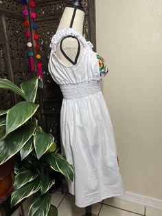 "Beautiful Floral Embroidered Elastic Loose Fit Dress - Handmade Embroidered Mexican Dress - Artisan Made Dress Beautiful hand embroidered dress! This has been made and brought directly from Puebla, Mexico. The dress has extremely detailed embroidery. The embroidery is 100% handcrafted. All the work on this dress has a professional skilled finish and the multicolor embroidered makes it look even more eye catching. The embroidery work is made with great quality thread. The eye catching will be on Hand Embroidered Dress, Embroidered Summer Dress, Embroidered Sun, Loose Fit Dress, White Embroidered Dress, Embroidered Apron, Mexican Dress, Detailed Embroidery, Made Dress