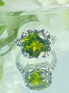 Natural Green Peridot Ring  Speechless Design#103 MADE TO ORDER Inspired by Victorian era filigree designs, I now offer this stunning Antique inspired ring in sterling silver (Solid 10K and 14K gold option also now available) at wholesale pricing. This fabulous ring is set with a 6ct stunning natural green peridot gemstone (AA to AAA clarity). The round full cut high-quality gemstone is 12mm (just shy of 1/2th of an inch) in diameter, and has very good color and clarity. The inside of the band i Peridot Center Stone Jewelry For May Birthstone, Lime Green Gemstone Ring Jewelry, Lime Green Gemstone Ring, Lime Green Jewelry With Accent Stones For Anniversary, Classic Peridot Jewelry For May Birthstone, Lime Green Peridot Jewelry With Center Stone, Lime Green Peridot Jewelry For Wedding, Lime Green Jewelry With Accent Stones For May Birthstone, Lime Green May Birthstone Jewelry With Accent Stones