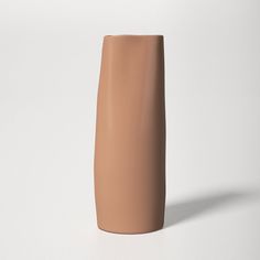 a brown vase sitting on top of a white table