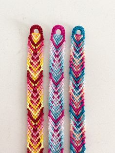 three bracelets made out of different colored beads