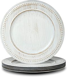 white dinner plates stacked on top of each other with beaded trim around the edges