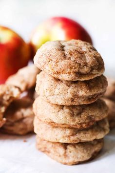 a stack of cookies sitting next to an apple