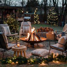 a fire pit surrounded by chairs and christmas lights