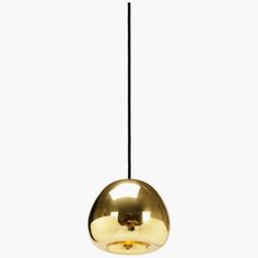 a gold colored light hanging from a black cord on a white background with the bottom half turned down