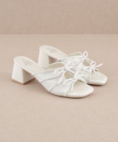 The Emerald | White Double Bow Peep Hole Sandal – Oasis Society White Formal Shoes, Unique Bridal Shoes, Cute White Sandals, Wedding Shoes Vintage, Emerald Blue, Classy Shoes, Double Bow, Stunning Shoes, Wrap Heels