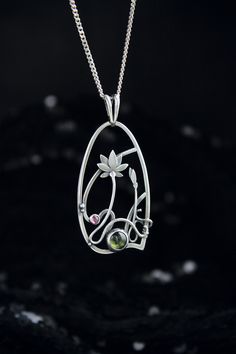 ITEM DESCRIPTION: The size H 4 cm x W 3 cm (1 3/4 x 1 inch). Weight - 6g. You can buy it with the chain or without. The most delicate flower of the lotus can make someone very happy. I made this botanical jewelry of sterling silver, peridot, and rhodolite garnet. This is a true work of art. It will emphasize your exquisite taste and status, and will also bring a lot of compliments. Ooak jewelry made by eco-friendly materials. The parcel will be sent during 1-2 days after payment. Delivery usuall Nature-inspired Pendant Necklace As Gift For Her, Bohemian Sterling Silver Flower Necklace, Nature-inspired Jewelry With Flower Charm Round Pendant, Nature-inspired Round Pendant Jewelry As A Gift For Her, Spiritual Birth Flower Pendant Jewelry, Bohemian Birth Flower Round Pendant, Nature-inspired Flower Gemstone Jewelry, Unique Green Flower Pendant Jewelry, Nature-inspired Oval Pendant Jewelry For Healing