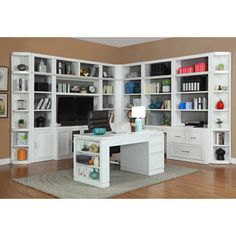 a white desk sitting in front of a book shelf filled with books and other items