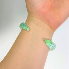 This bracelet is as tough as it is unique. If you break it we will ship you a new one for free. The intriguing contours create a sensual form. Our Borosilicate glass artisan cuff bracelets are handmade by glass craftsmen with the centuries-old process known as lampwork. The borosilicate glass is molded and formed into the cuff shape with precision and attention to detail. The cuff is then annealed in a kiln to ensure durability and strength, making it the perfect material for unique wearable art Dog Carrier Sling, Dog Sling, Etsy Cards, Cuff Bangle Bracelet, Pyrex Glass, Cuff Bangles, Pyrex, Colorful Interiors, Bangle Bracelet