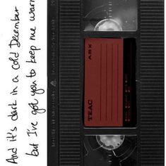 an old vhs tape recorder with writing on it and a red cassette attached to the side