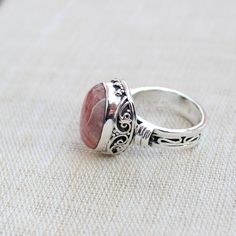 Gemstone - Rhodochrosite Gemstone Size - 12x16 oval Metal - Sterling Silver Ring Size - All sizes Available Natural pink rhodochrosite sterling silver handmade ring Rhodochrosite attracts love by opening up the heart chakras with its healing vibrations. It gives us the inner strength to take another chance at love because even if you fall, the Rhodochrosite crystal will always catch you. The ring can be customized on request and gemstone can be switched to any gemstone you want. Feel free to con Unique Oval Crystal Gemstone Ring, Oval Moonstone Ring For Gift, Unique Oval Crystal Ring With Natural Stones, Moonstone Ring With Large Oval Stone For Gift, Unique Oval Crystal Ring With Gemstone, Oval Moonstone Ring Gift, Handmade Oval Gemstones For Wedding, Oval Natural Stones Jewelry For Wedding, Unique Oval Rings As Gift