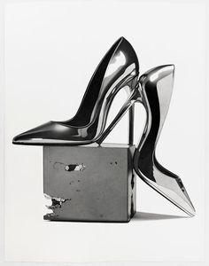 a pair of high heeled shoes sitting on top of a box