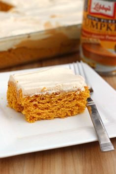 a piece of cake sitting on top of a white plate next to a knife and fork